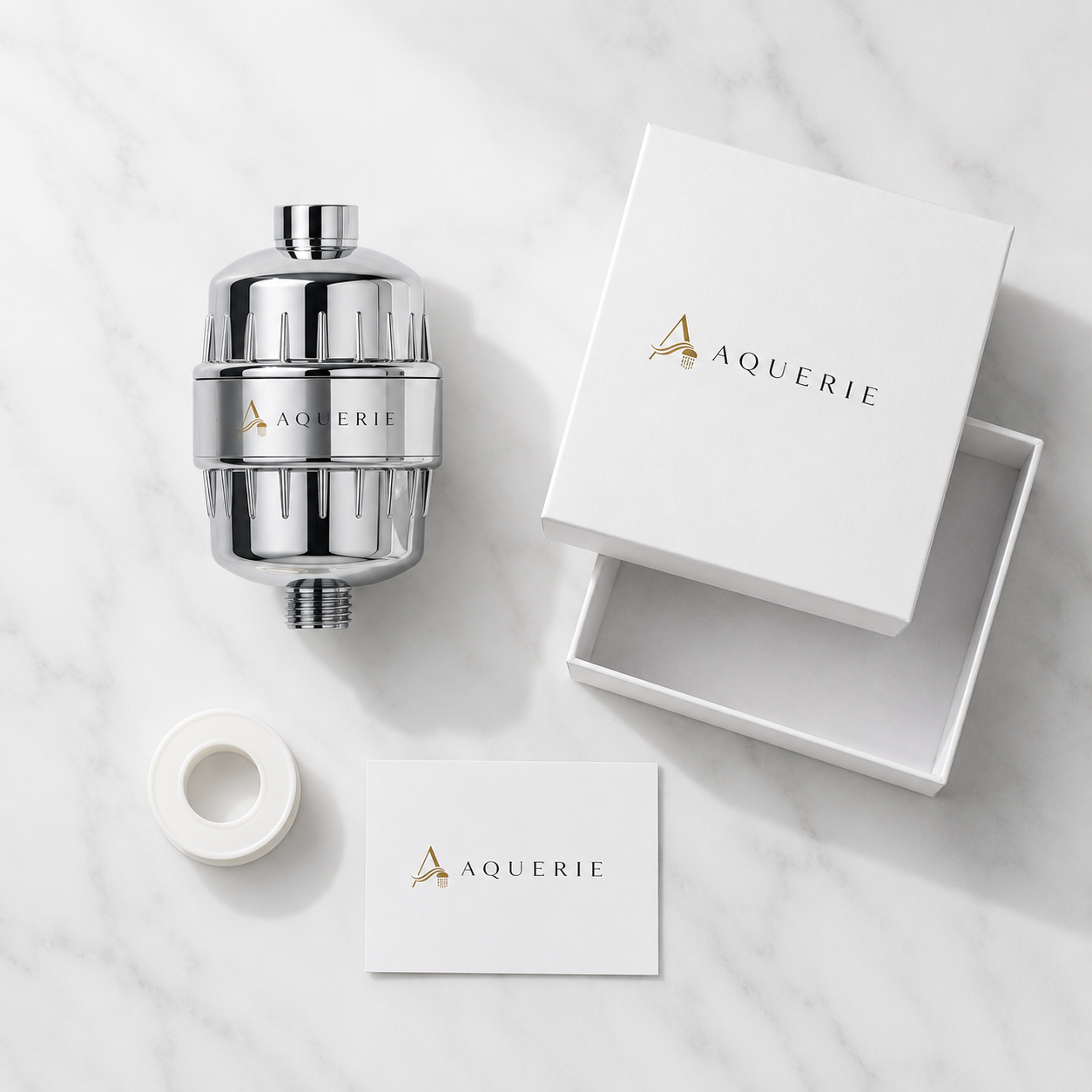 AQUERIE Rituel shower filter unboxing flat lay — filter, gift box, PTFE tape and instruction card