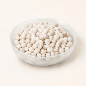 A white bowl of pale calcium sulfite beads.